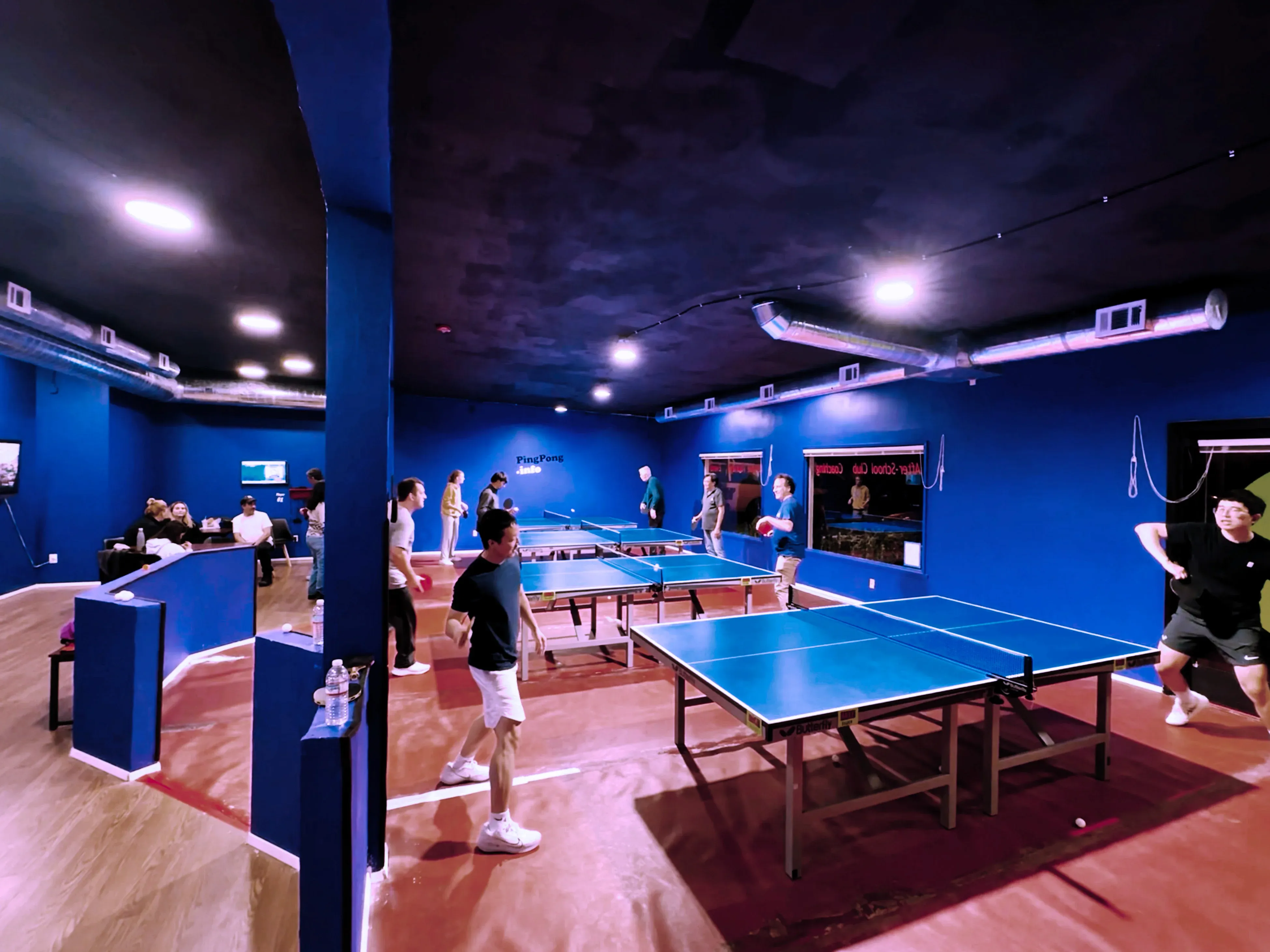 background image of a group of people playing ping pong